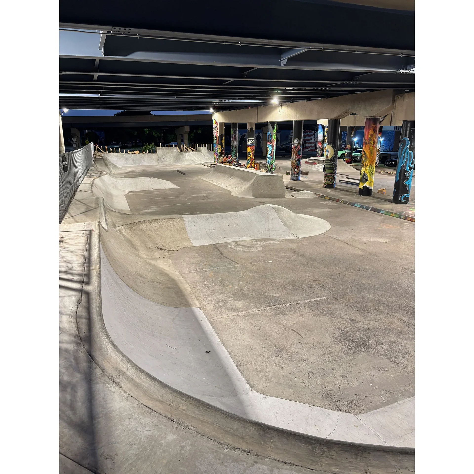 Wide photo shot of National DIY Skatepark lit up at night.